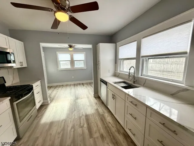 a kitchen with granite countertop a stove and a sink