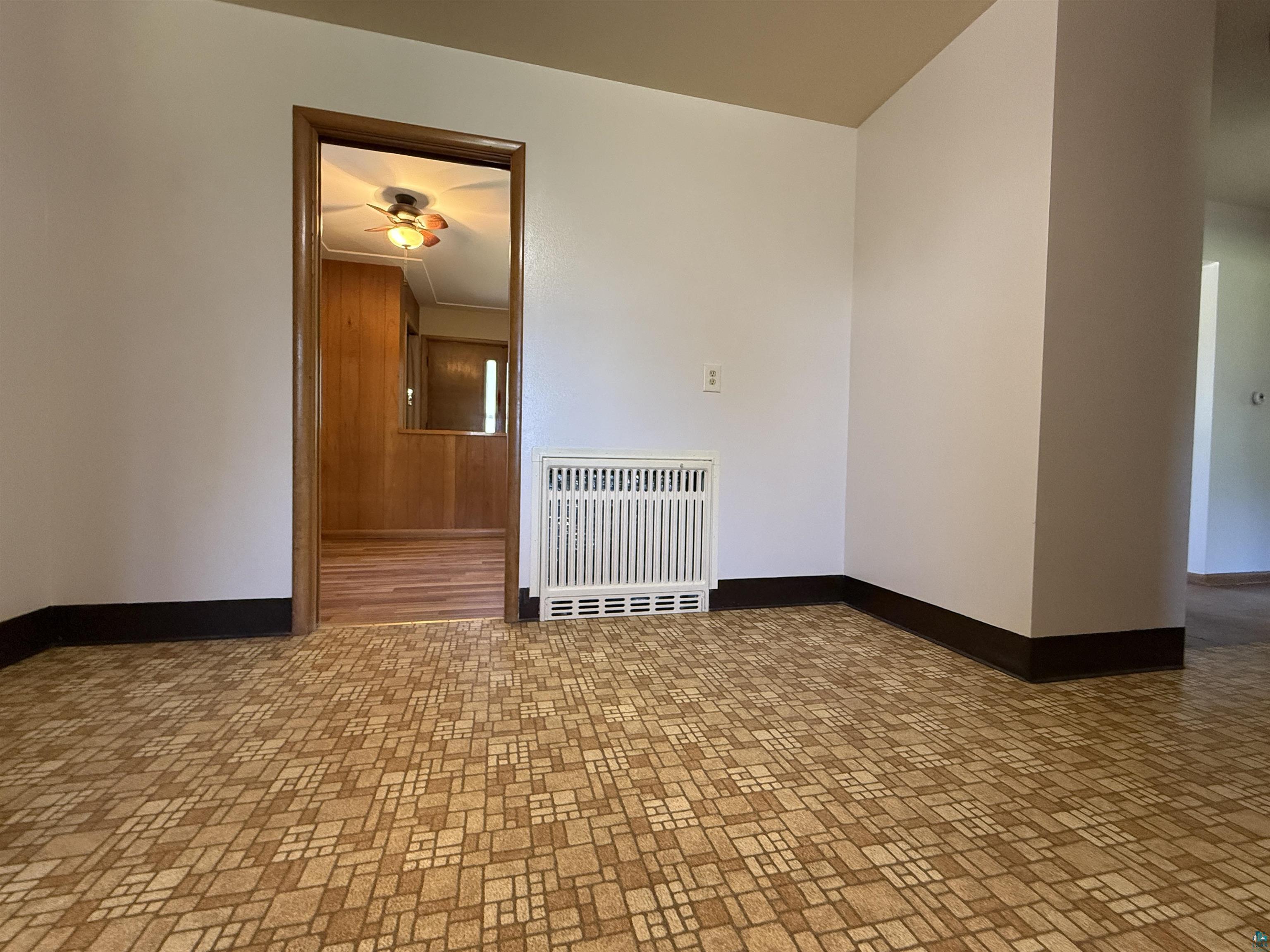 607 3rd Street Northeast Chisholm, MN 55719 - Photo 12 of 32 Interior space featuring patterned flooring, white walls, and dark baseboards