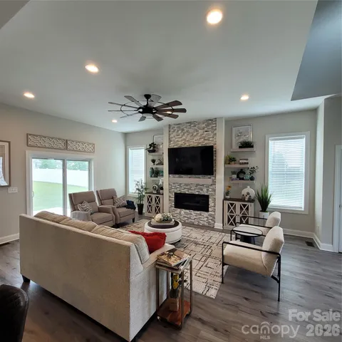 a living room with fireplace furniture and a flat screen tv