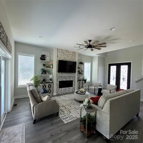 a living room with furniture flat screen tv and fireplace
