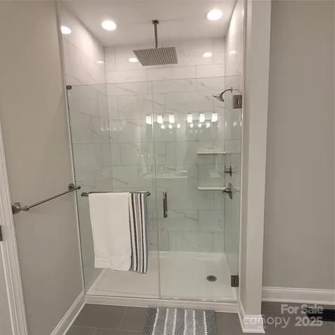 a bathroom with a glass shower door