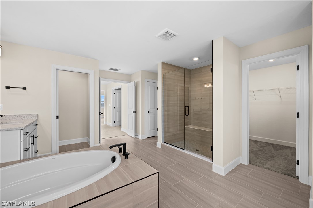 42548 Little Ridge Road Punta Gorda, FL 33982 - Photo 24 of 50 a bathroom with a tub shower vanity and a sink