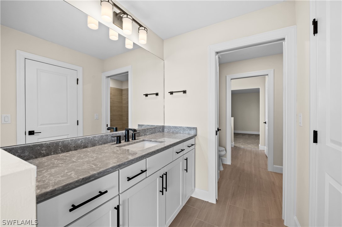 42548 Little Ridge Road Punta Gorda, FL 33982 - Photo 26 of 50 a bathroom with a granite countertop sink and a mirror