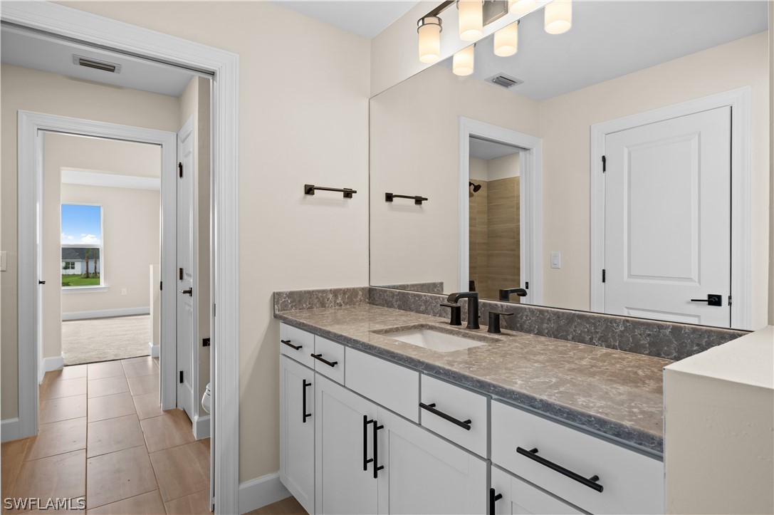 42548 Little Ridge Road Punta Gorda, FL 33982 - Photo 29 of 50 a bathroom with a granite countertop sink and a mirror