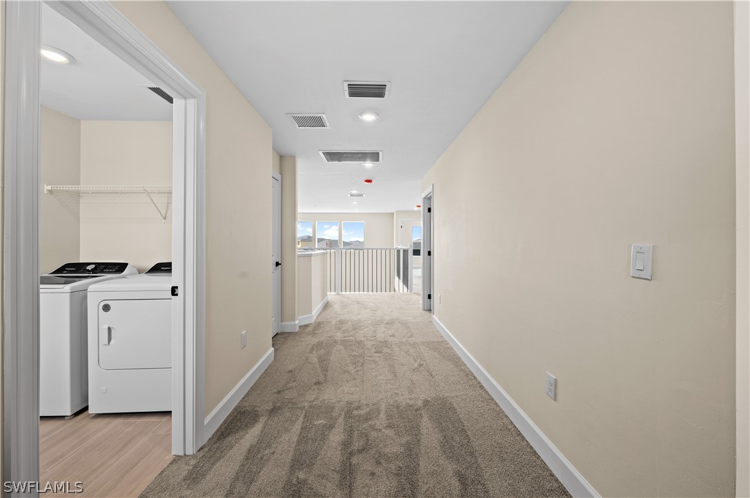 42548 Little Ridge Road Punta Gorda, FL 33982 - Photo 32 of 50 a view of a hallway with wooden floor and closet