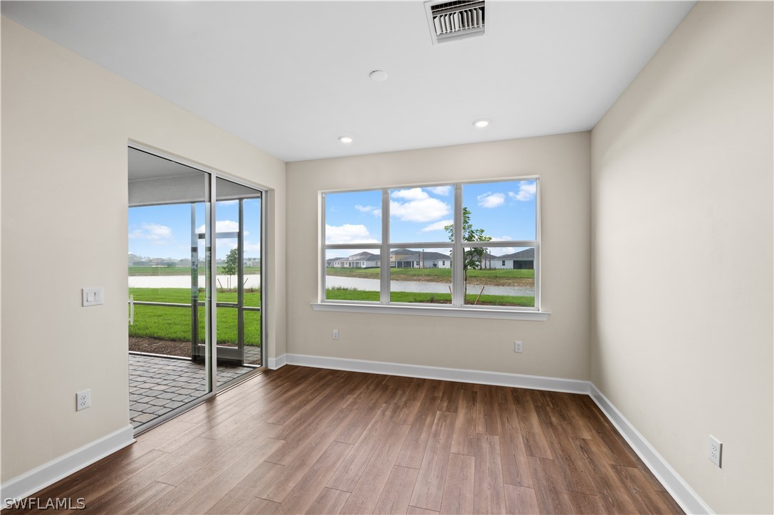 42548 Little Ridge Road Punta Gorda, FL 33982 - Photo 36 of 50 an empty room with wooden floor and windows