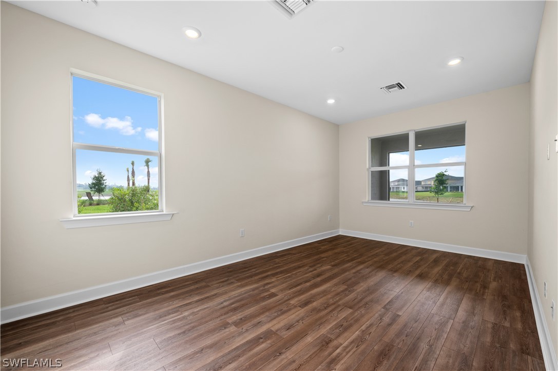 42548 Little Ridge Road Punta Gorda, FL 33982 - Photo 39 of 50 an empty room with wooden floor and windows