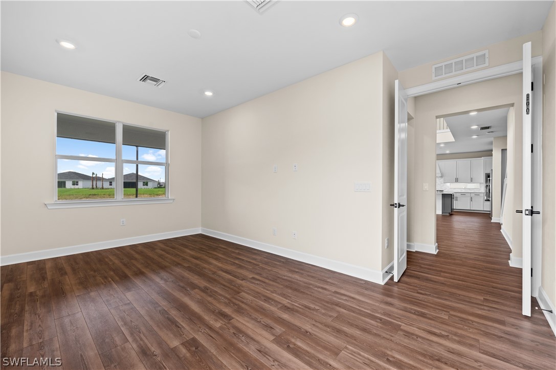42548 Little Ridge Road Punta Gorda, FL 33982 - Photo 40 of 50 a view of an empty room with wooden floor and a window