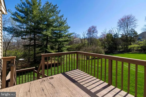 a balcony with wooden floor and fence