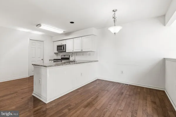 a kitchen with a refrigerator sink and cabinets