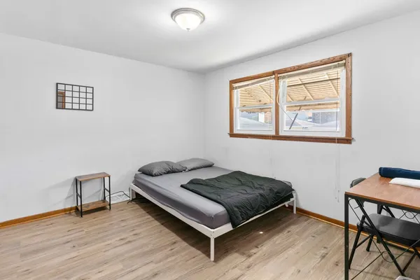 a bedroom with a bed and a desk