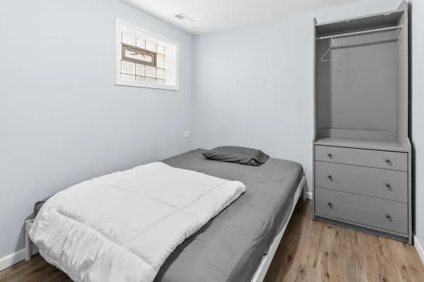 a bedroom with a bed and cabinet