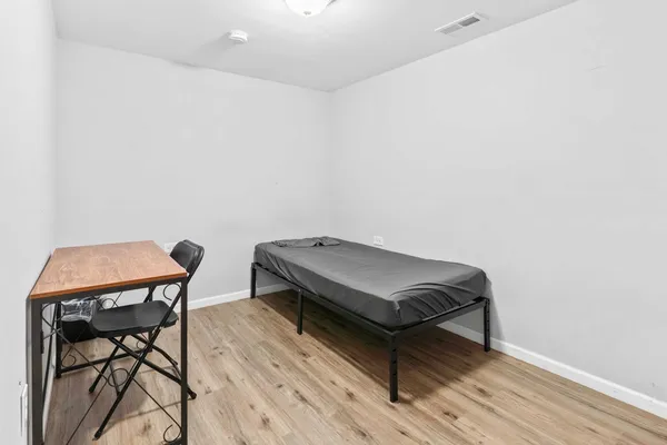 a room with a chair and wooden floor