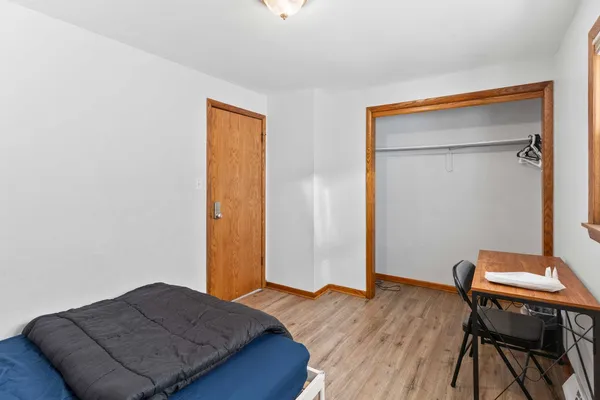 a bedroom with a bed and a desk