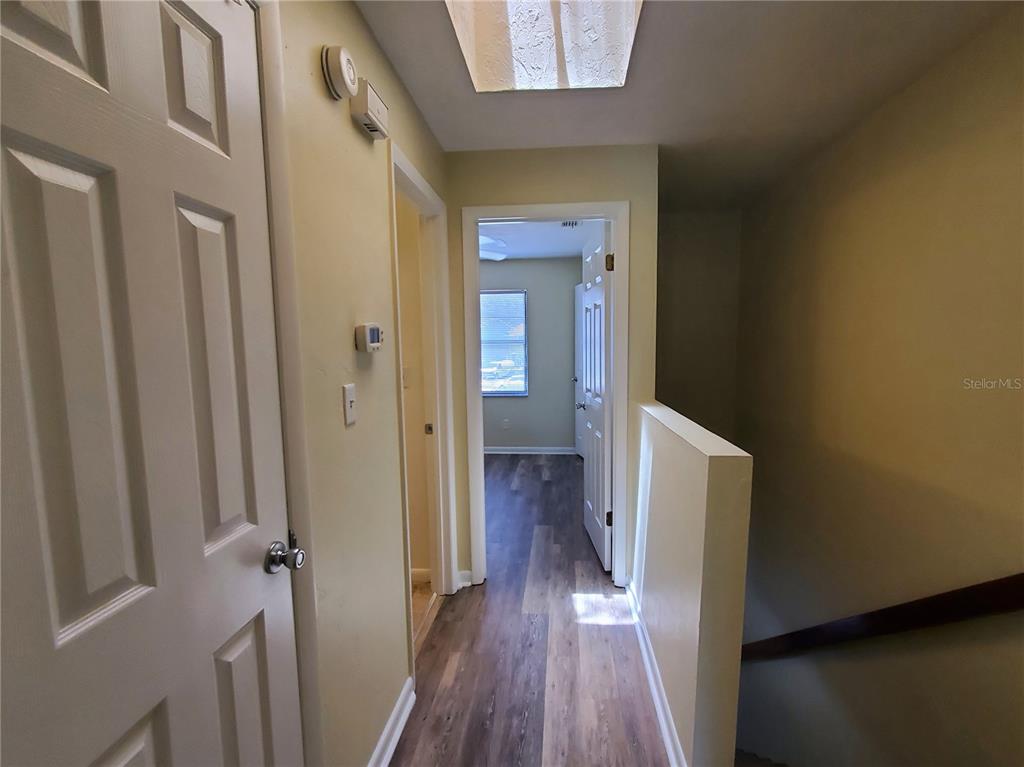 2207 Southwest 39 Drive Gainesville, FL 32607 - Photo 12 of 22 a view of a hallway with wooden floor