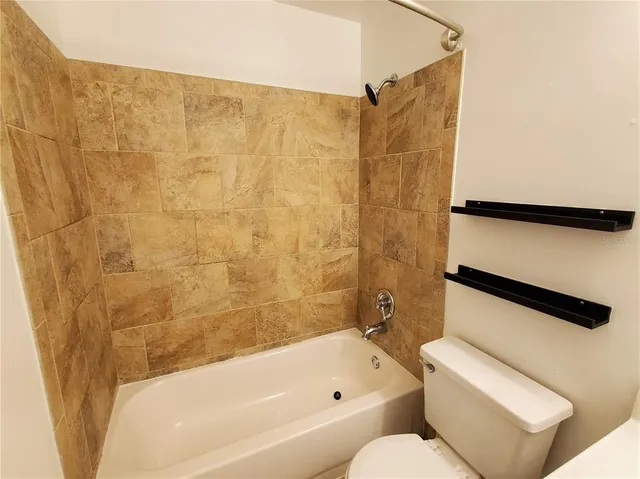 a bathroom with a toilet and a bathtub