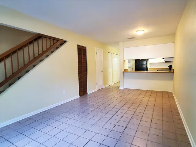 a view of a kitchen with wooden floor and electronic appliances