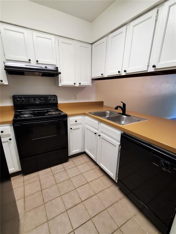 2207 Southwest 39 Drive Gainesville, FL 32607 - Photo 4 of 22 a kitchen with stainless steel appliances granite countertop a sink and a stove