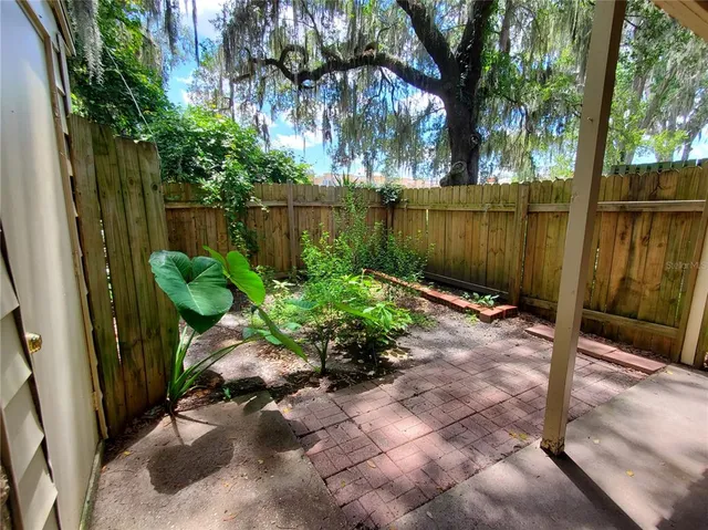 a garden with trees in front of it