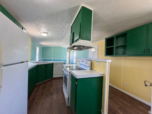2491 Highway 89, Unit 315 Pleasant View, UT 84404 - Photo 11 of 34 Kitchen featuring wood-finish flooring, green cabinetry, white countertops, and white appliances including a refrigerator, range, and dishwasher