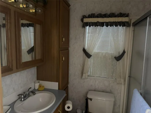 a bathroom with a sink toilet and shower