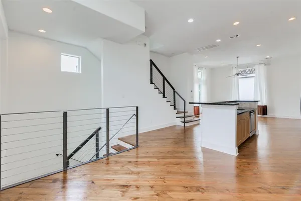 a view of entryway and kitchen with wooden floor