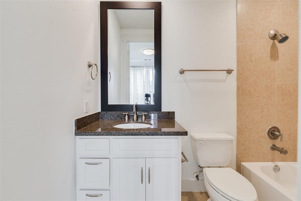 2002 Blodgett Street Houston, TX 77004 - Photo 31 of 43 a bathroom with a granite countertop sink toilet and mirror