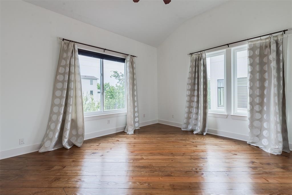 2002 Blodgett Street Houston, TX 77004 - Photo 33 of 43 an empty room with wooden floor and windows