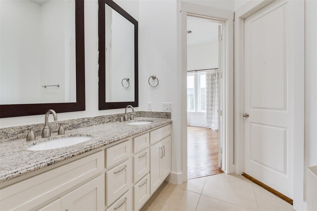 2002 Blodgett Street Houston, TX 77004 - Photo 38 of 43 a bathroom with a granite countertop double vanity sink and a mirror