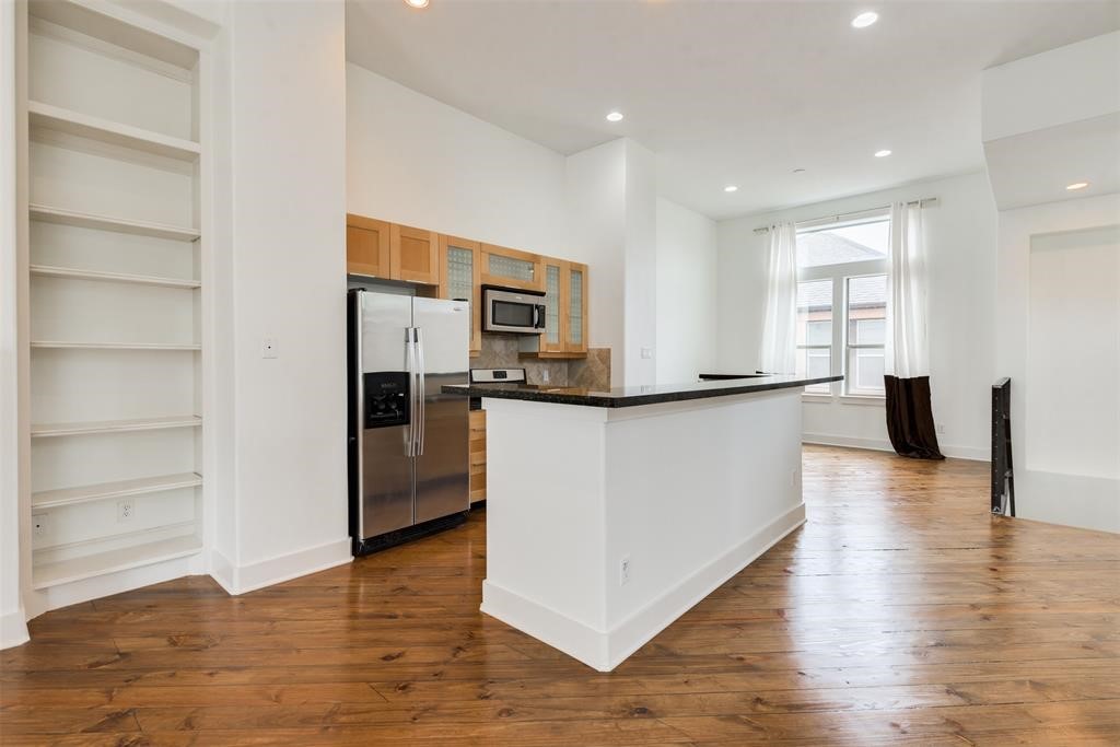 2002 Blodgett Street Houston, TX 77004 - Photo 9 of 43 a view of a kitchen with refrigerator and wooden floor