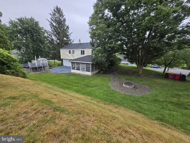 a view of a backyard with a garden and trees