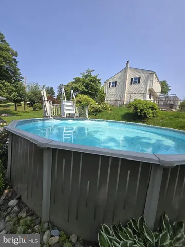 a view of a backyard with a fountain plants and large tree