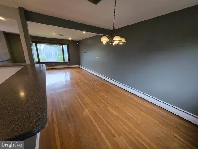 a kitchen with a refrigerator sink and wooden cabinets