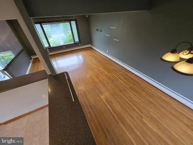 a view of room with window and hardwood floor