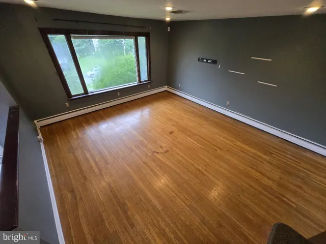 a view of room with window and wooden floor