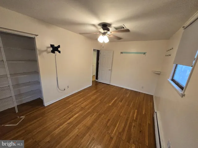 an empty room with windows and fireplace