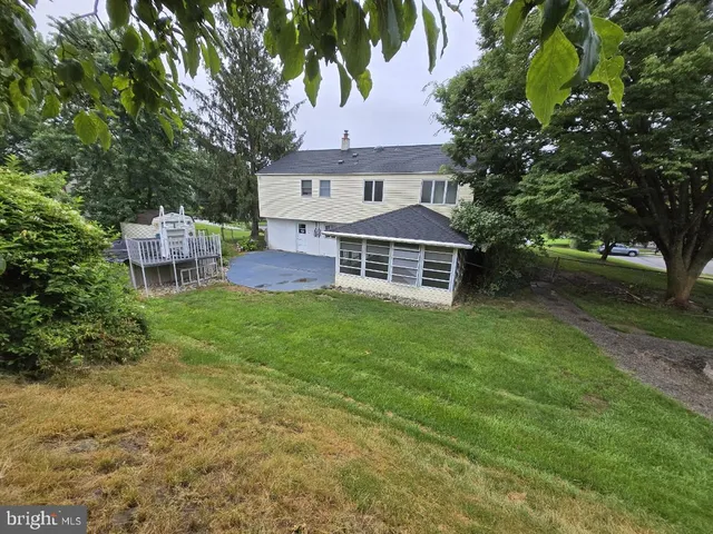a view of a house with a yard and sitting area
