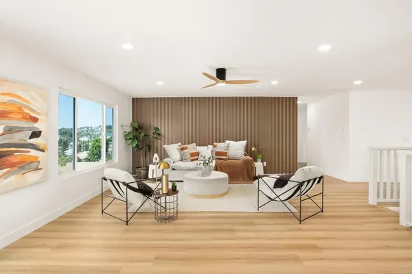 a living room with furniture and a wooden floor