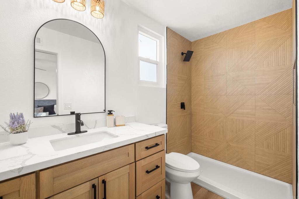 552 Felicita Avenue Spring Valley, CA 91977 - Photo 23 of 44 a bathroom with a sink a toilet and a mirror