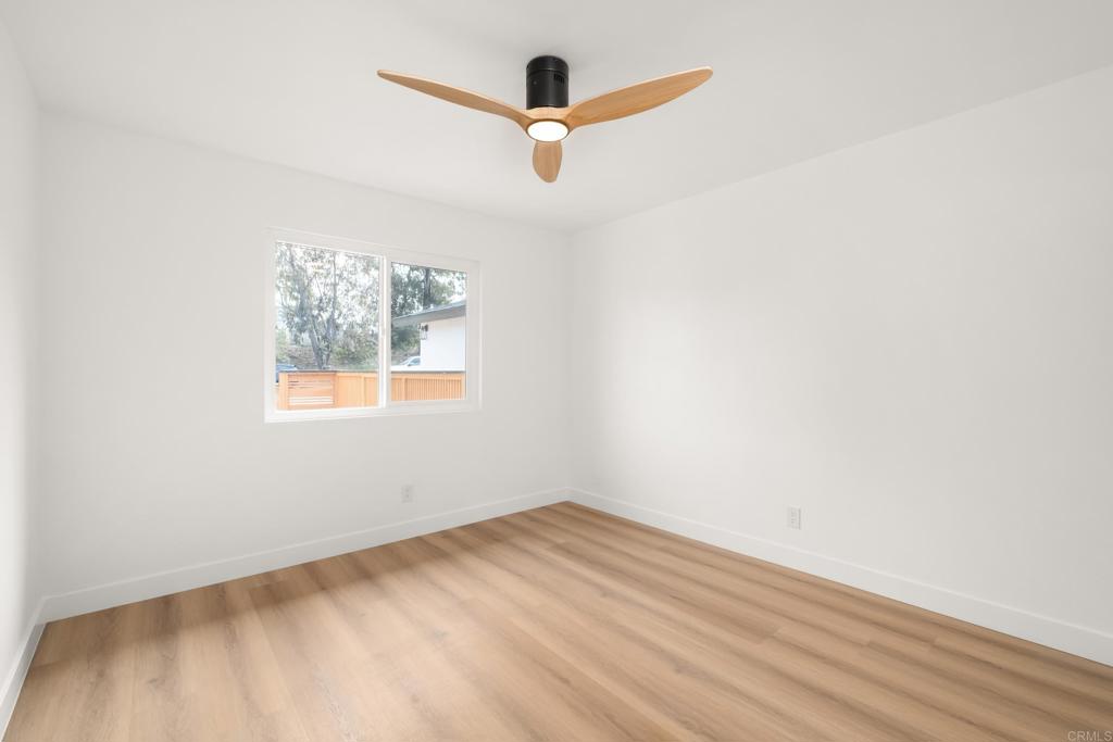 552 Felicita Avenue Spring Valley, CA 91977 - Photo 24 of 44 an empty room with wooden floor and ceiling fan