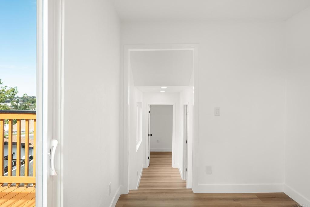 552 Felicita Avenue Spring Valley, CA 91977 - Photo 27 of 44 a view of a hallway with wooden floor and a bathroom