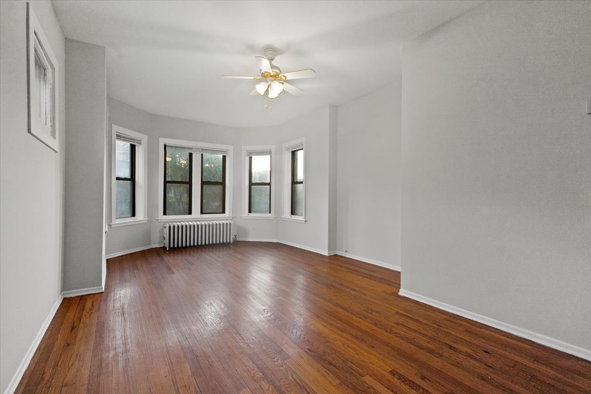 6700 South Merrill Avenue, Unit 3E Chicago, IL 60649 - Photo 2 of 12 a view of an empty room with wooden floor