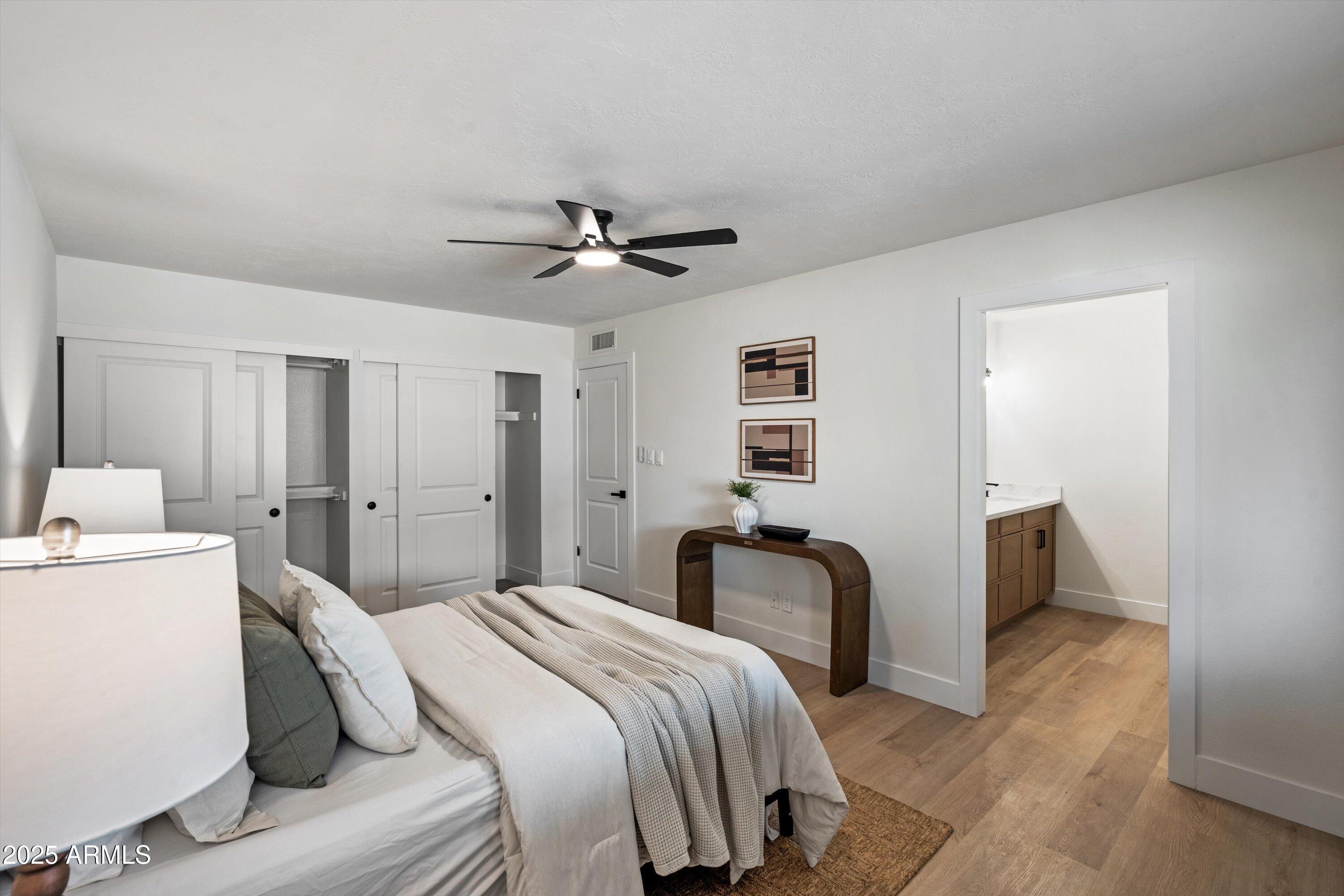 2116 East Colgate Drive Tempe, AZ 85283 - Photo 11 of 29 a spacious bedroom with a bed and a chandelier