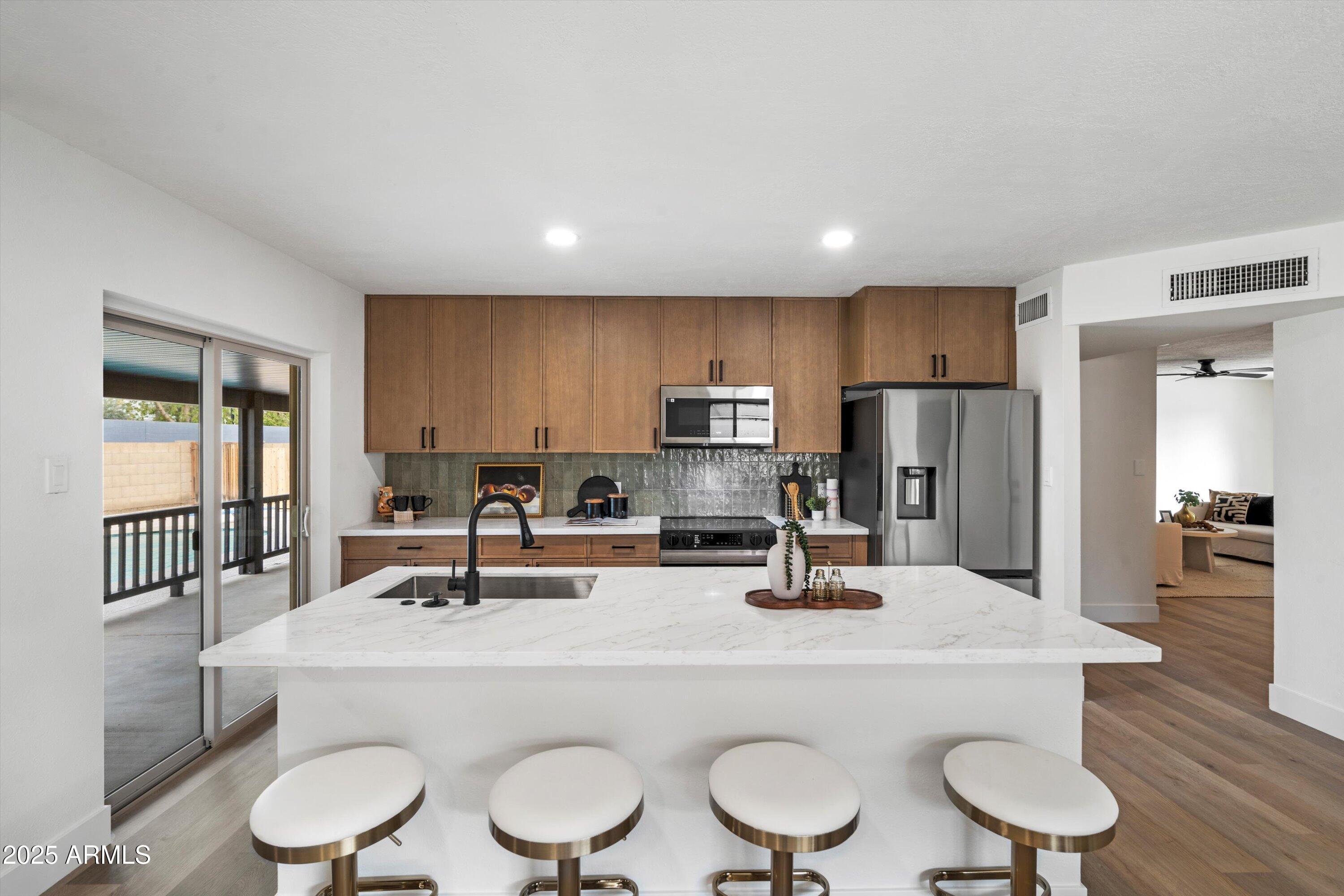 2116 East Colgate Drive Tempe, AZ 85283 - Photo 15 of 29 a kitchen with a table chairs stove and refrigerator
