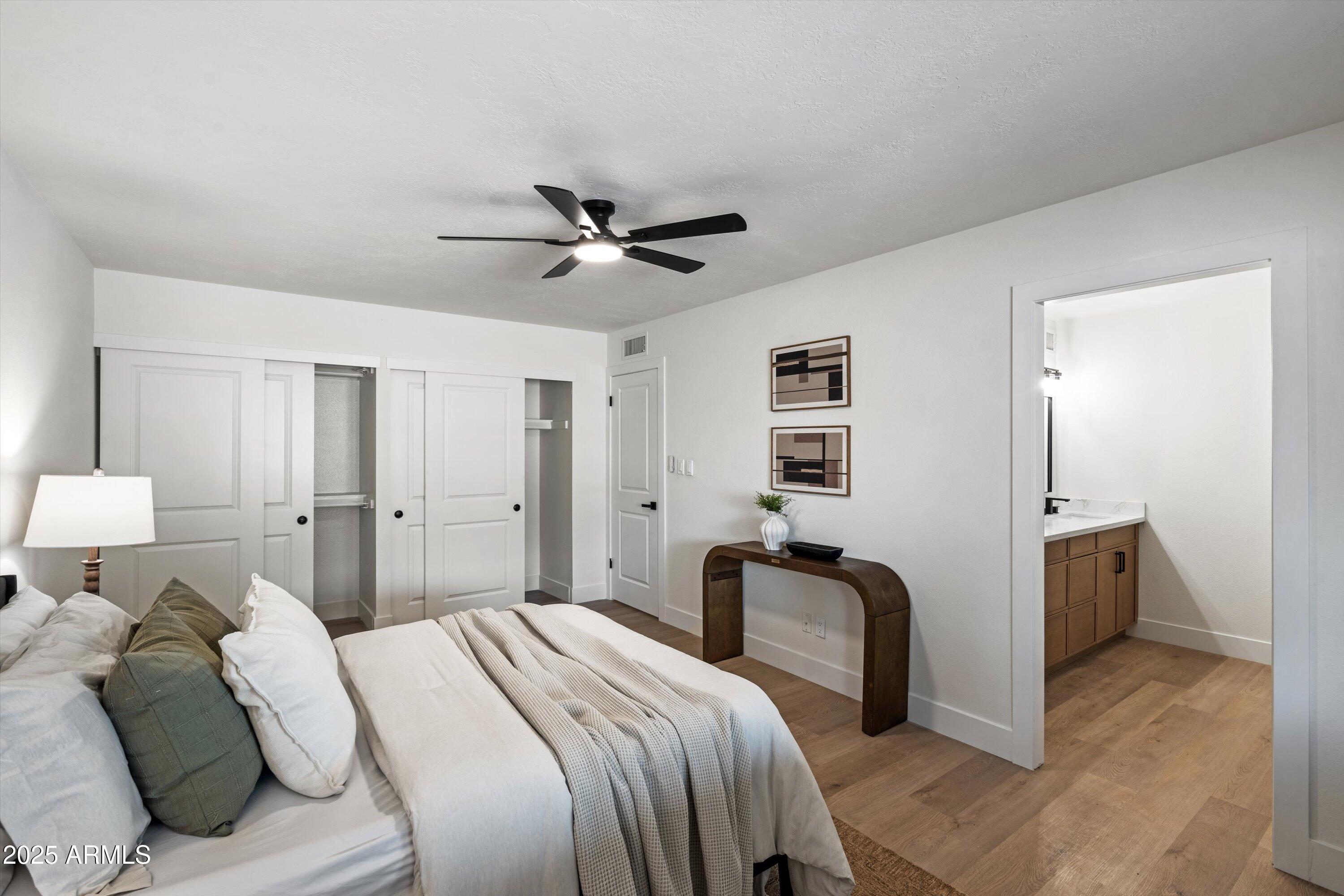 2116 East Colgate Drive Tempe, AZ 85283 - Photo 17 of 29 a bedroom with a bed and a chandelier