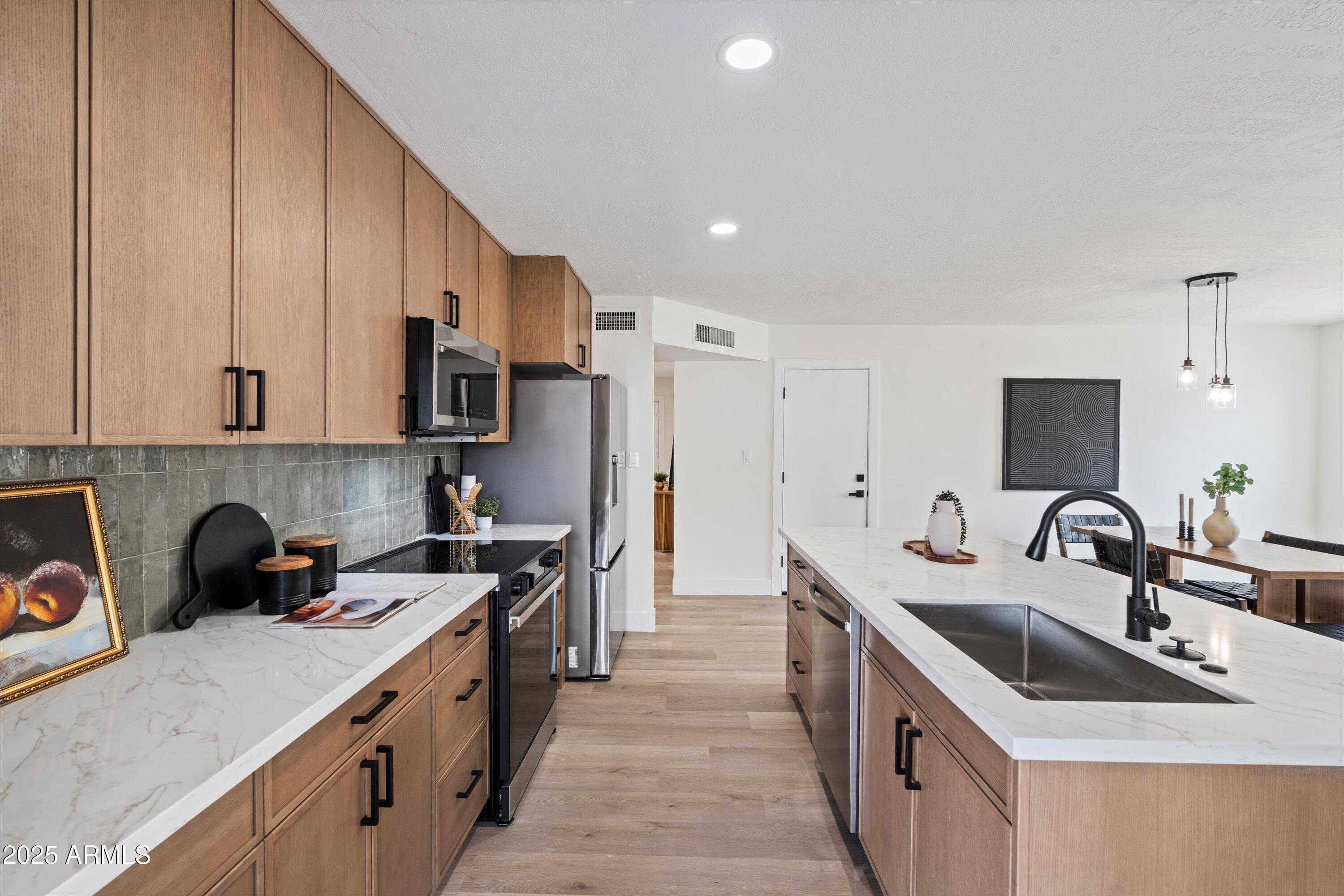 2116 East Colgate Drive Tempe, AZ 85283 - Photo 20 of 29 a kitchen with stainless steel appliances a sink stove and refrigerator