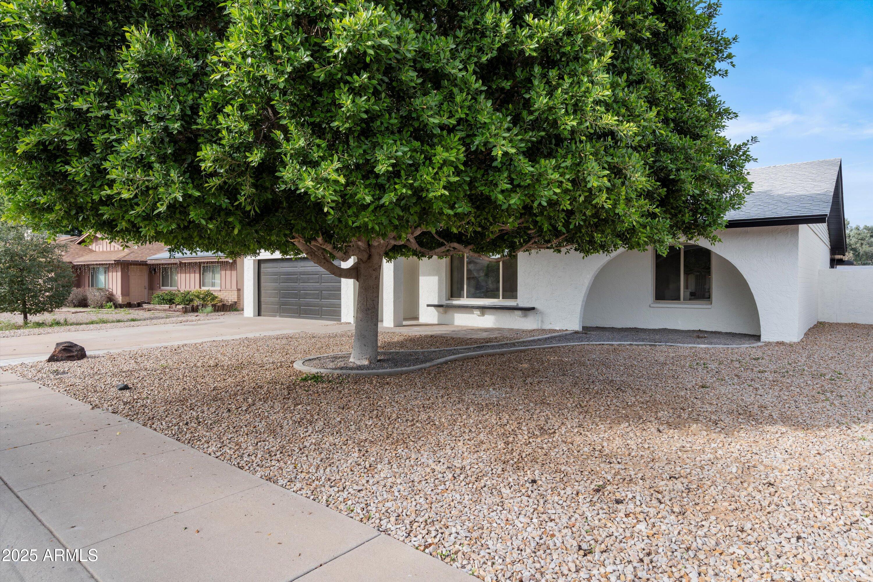 2116 East Colgate Drive Tempe, AZ 85283 - Photo 24 of 29 a house with trees in the background