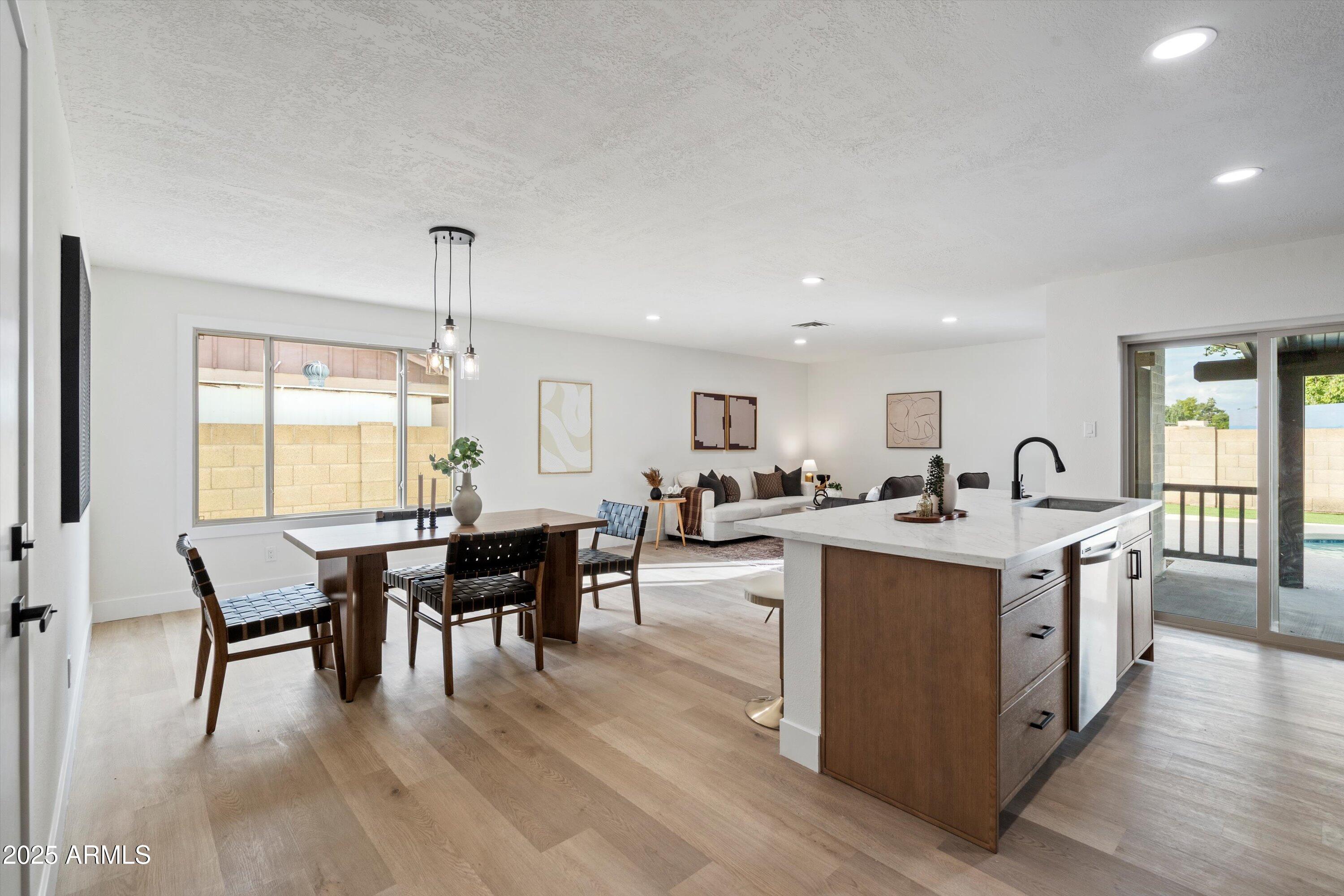 2116 East Colgate Drive Tempe, AZ 85283 - Photo 4 of 29 a view of a dining room with furniture and wooden floor