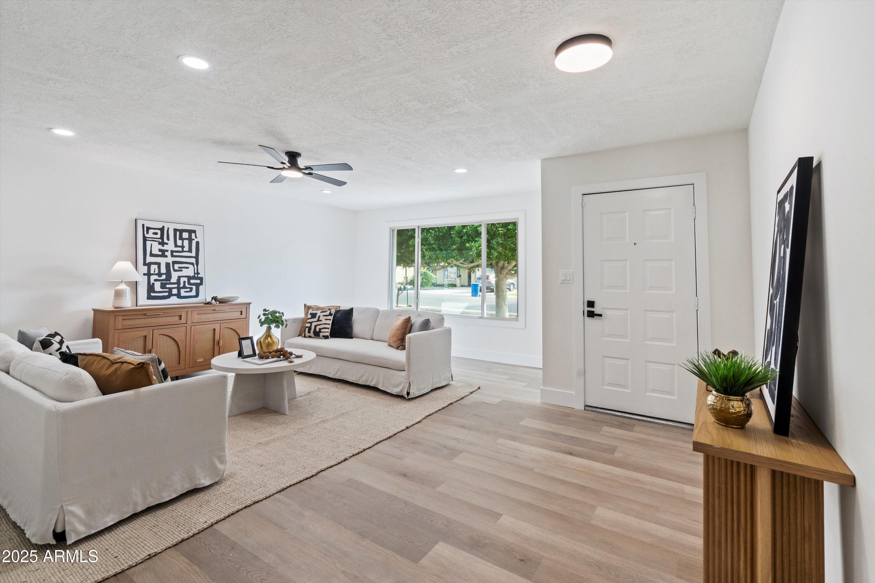 2116 East Colgate Drive Tempe, AZ 85283 - Photo 7 of 29 a living room with furniture and a potted plant