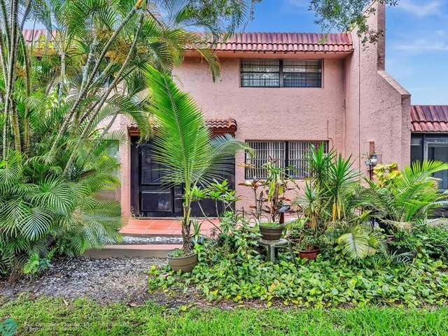 a view of a house with a flower garden
